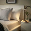 BÄRGLIM grey fitted sheet on bed