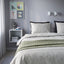 PILTANDVINGE grey duvet set, on a bed