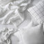 SÄFFEROT duvet styled as part of a white bedding set with matching pillowcases and sheet