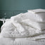SMÅSPORRE light warm duvet folded neatly on a bed